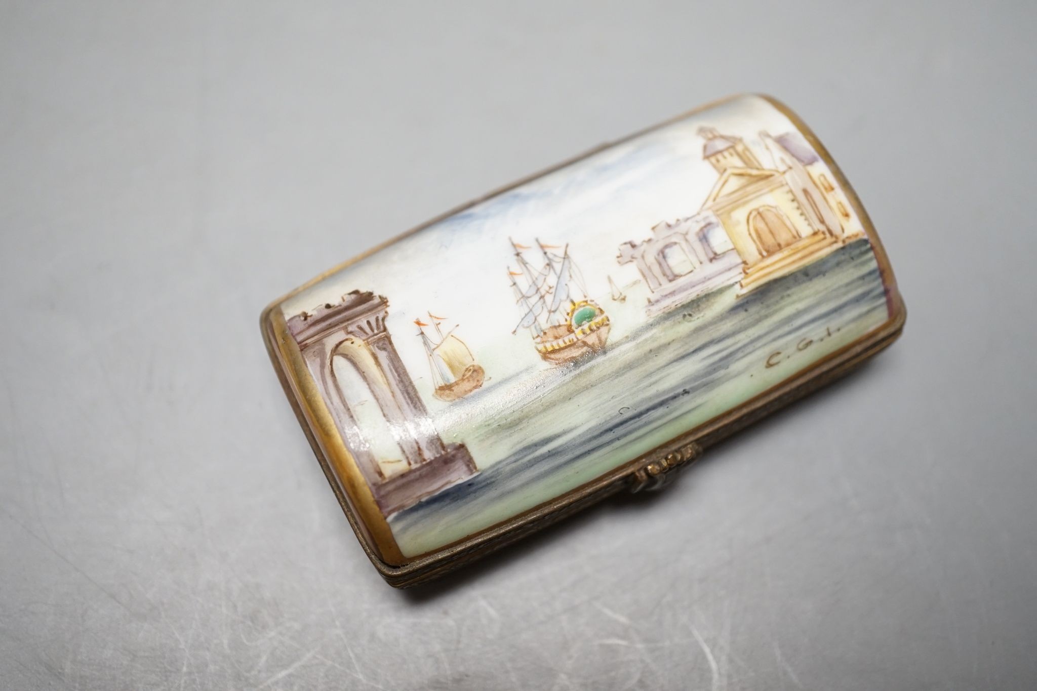 A Russian oval lacquered box, 10cm., and a porcelain box painted with ships approaching harbour
